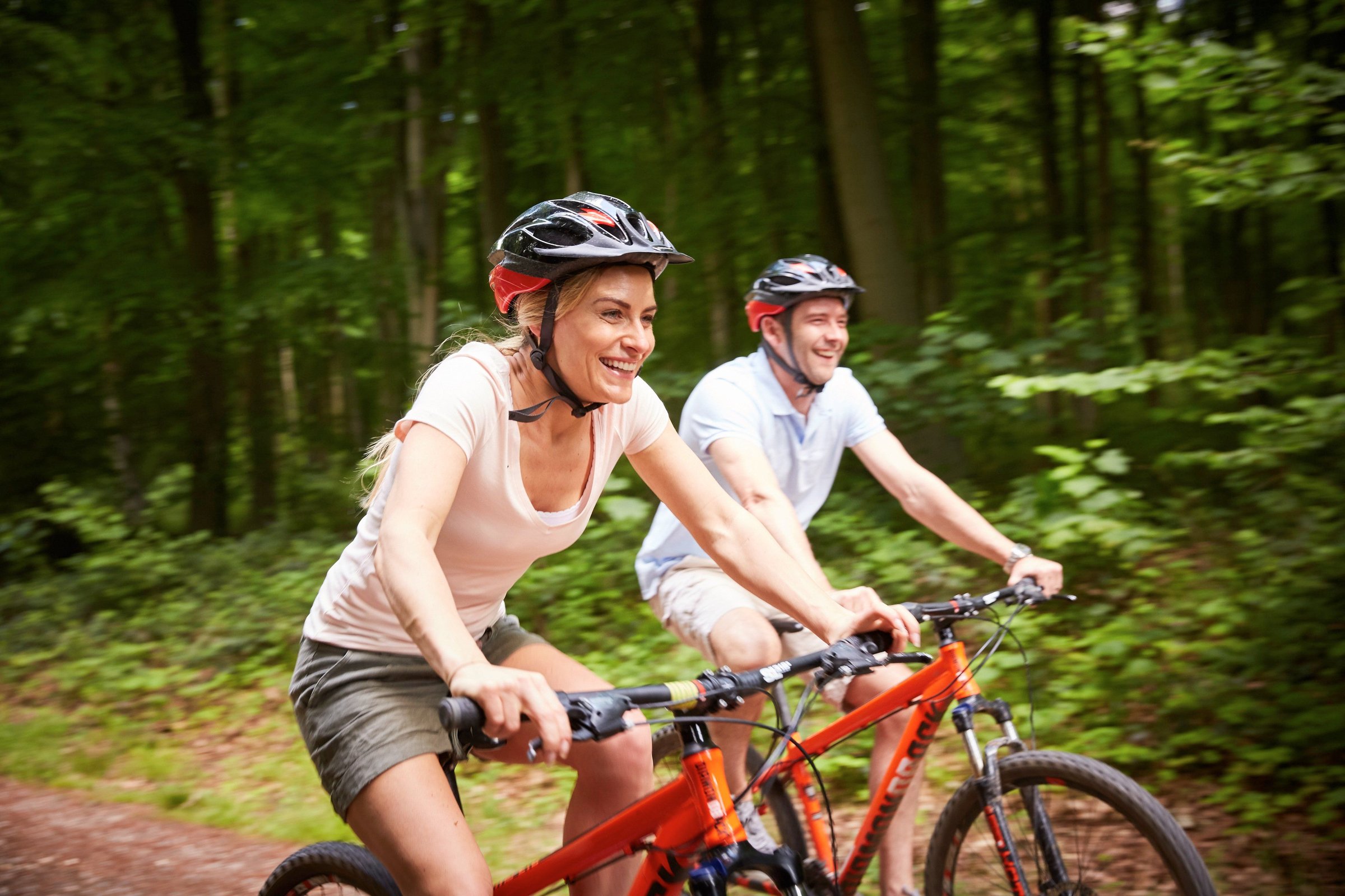 A couple cycling at Blackwood Forest, Forest Holidays