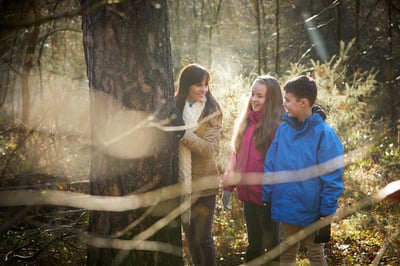 A family of three on a forest fairy hunt at Forest Holidays
