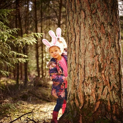 Young girl dressed with bunny ears in the forest