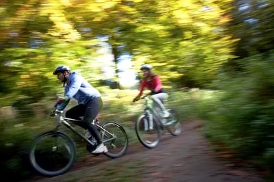 Couple cycling through the Forest of Dean, Forest Holidays