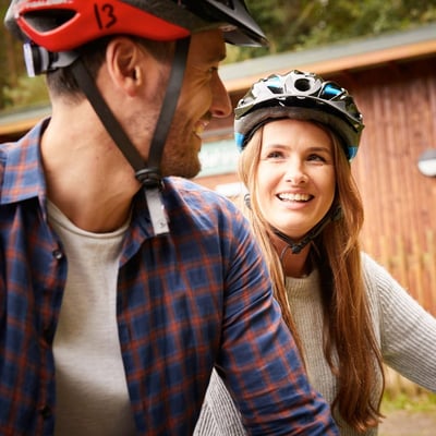 Couple cycling through the forest on their cycling holiday