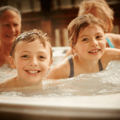 Family enjoying a hot tub at Forest Holidays