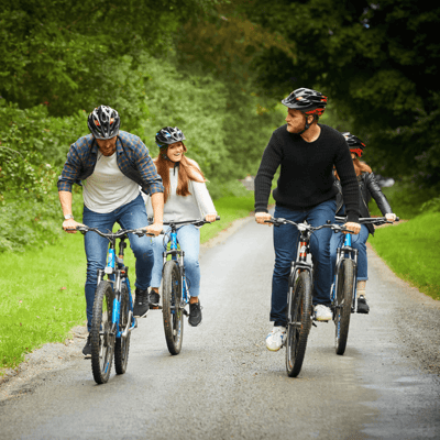 Group of friends cycling through the forest