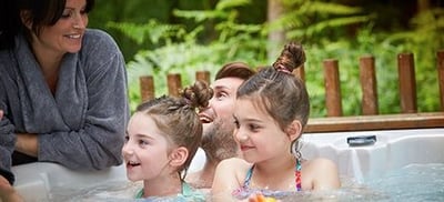 Family in the hot tub at Forest Holidays