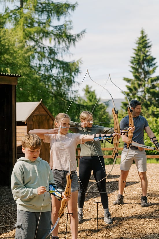 A family taking part in archery