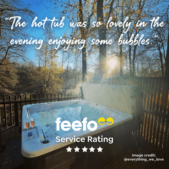 Photo of hot tub in the forest with review text: The hot tub was so lovely in the evening enjoying some bubbles"
