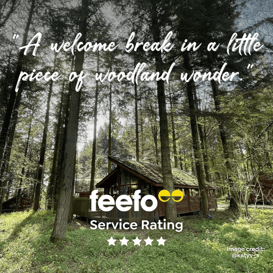 Photo of a log cabin in forest with review text: A welcome break in a little piece of woodland wonder