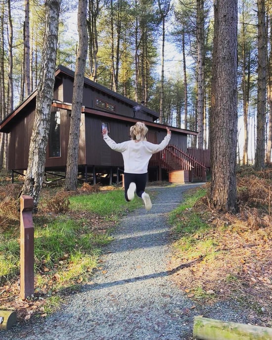 Person jumping in the air at Forest Holidays