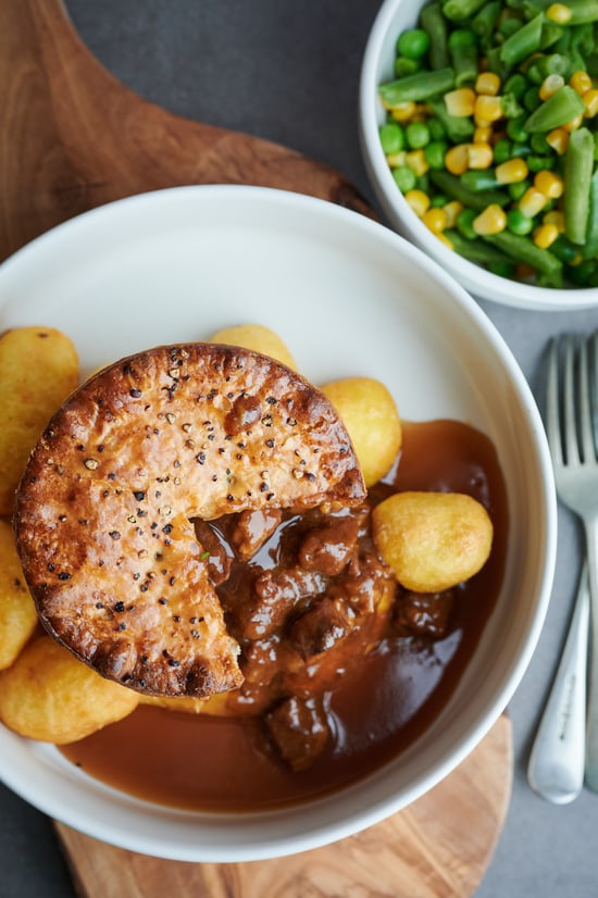 Aerial view of pie, potatoes and greens