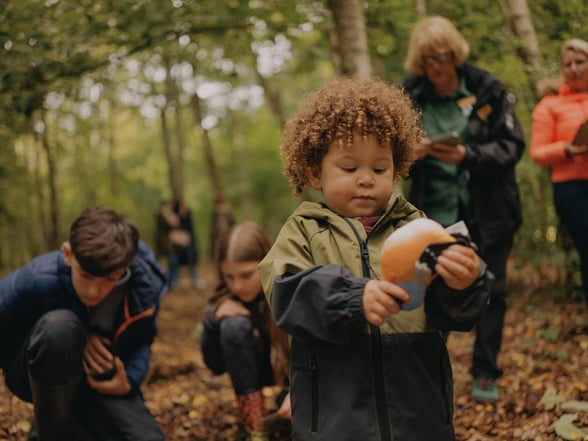 A child holding a toy bird