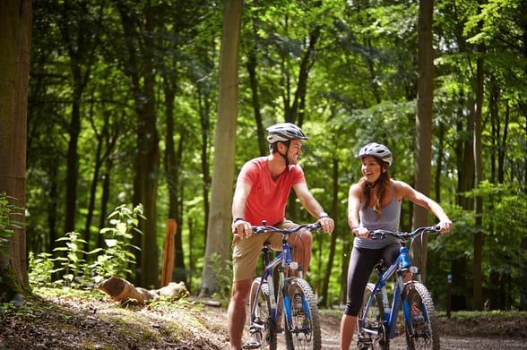 Couple cycling in the forest