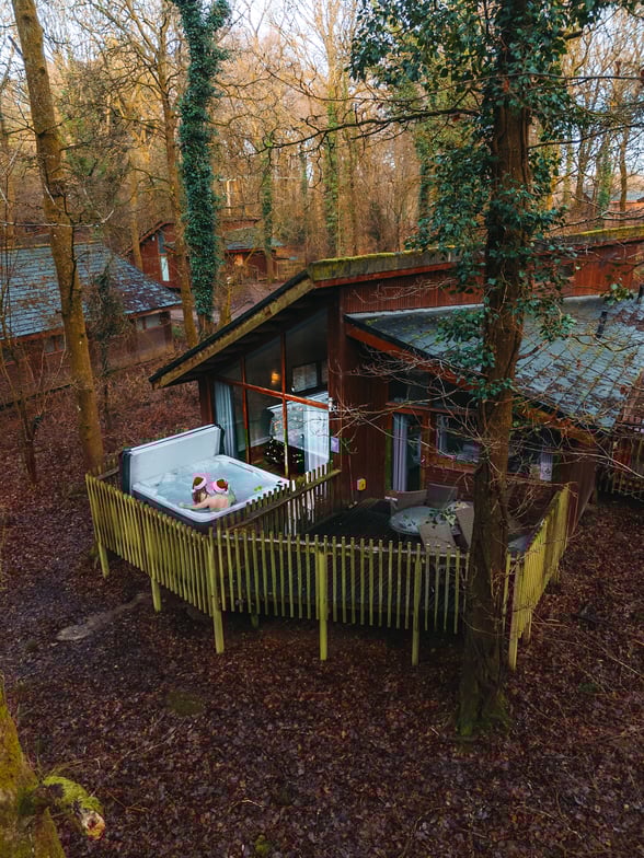 People wearing santa hates in a hot tub