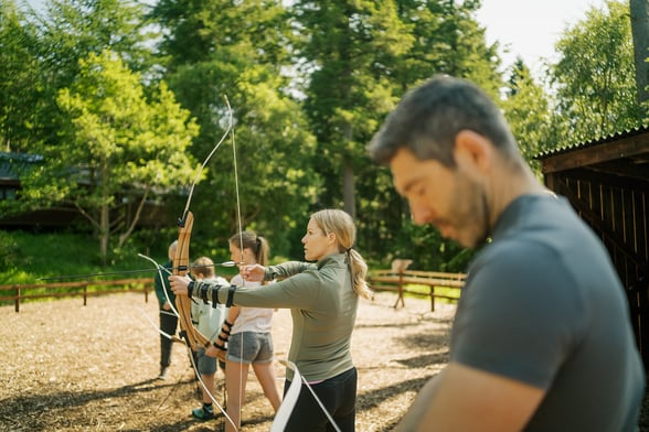 A family taking part in archery
