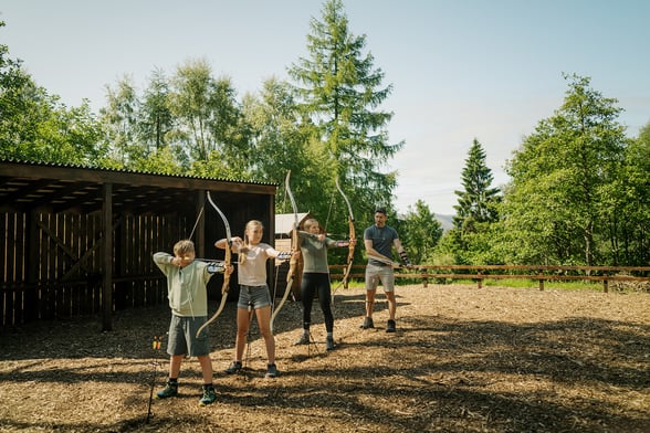 A family taking part in archery