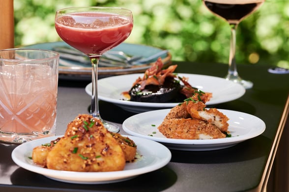 Tapas dishes with three cocktails