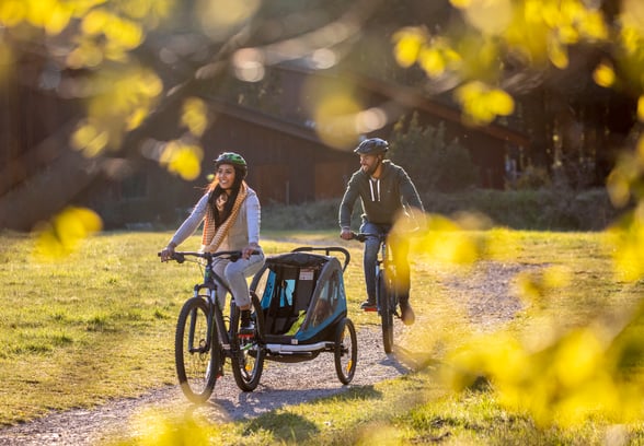 Family cycling through the forest
