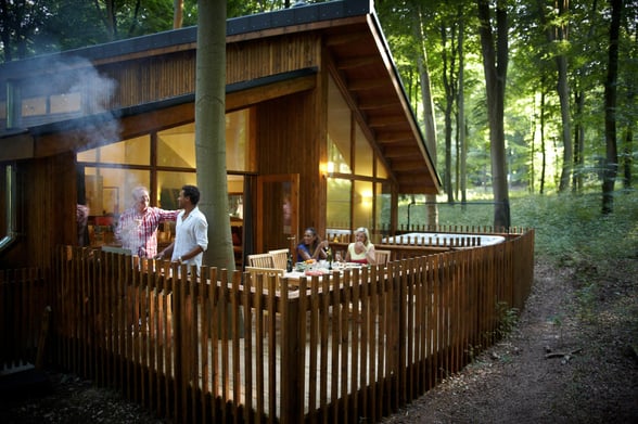 Group enjoying a barbecue on the decking at Blackwood Forest