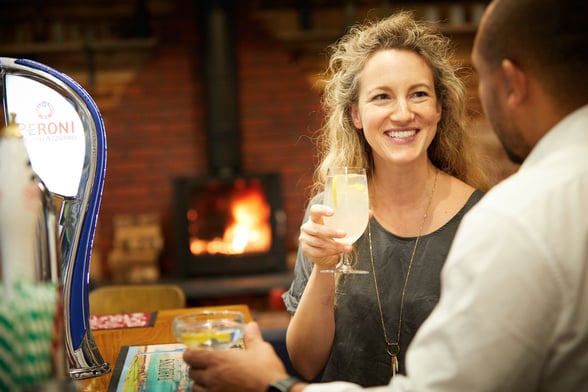 Couple drinking at the Forest Retreat bar at Forest Holidays