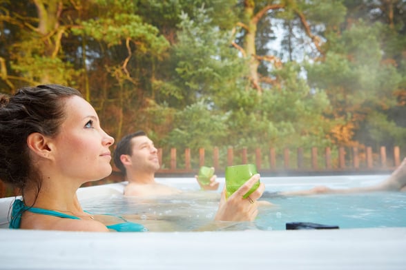 Couple in hot tub at Forest Holidays