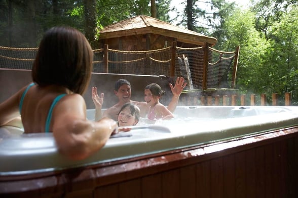 Family in hot tub at Forest Holidays