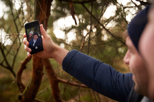People in the forest on their phone