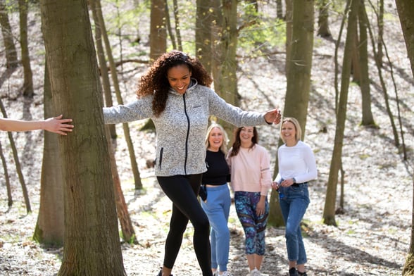 Group of ladies walking through the forest