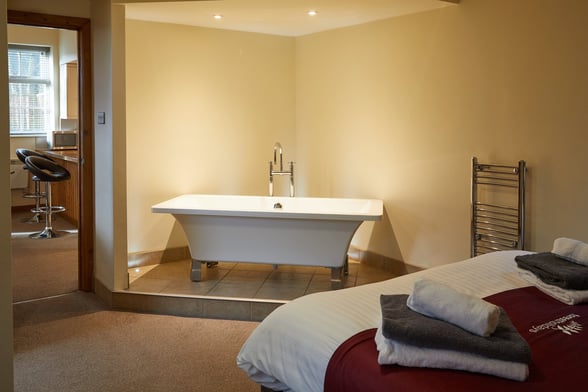 Freestanding bath inside the Golden Oak Cottage at Keldy, Forest Holidays
