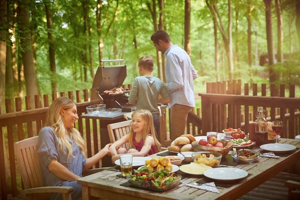 Family on the decking at Forest Holidays