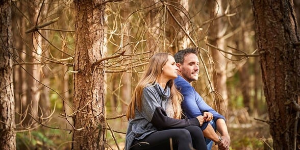 A couple sat in the forest