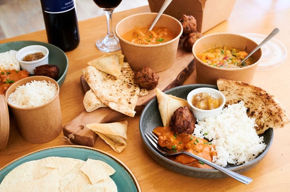Takeaway curry pack presented on a table