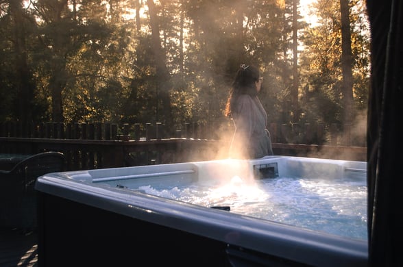 Woman stood next to a hot tub