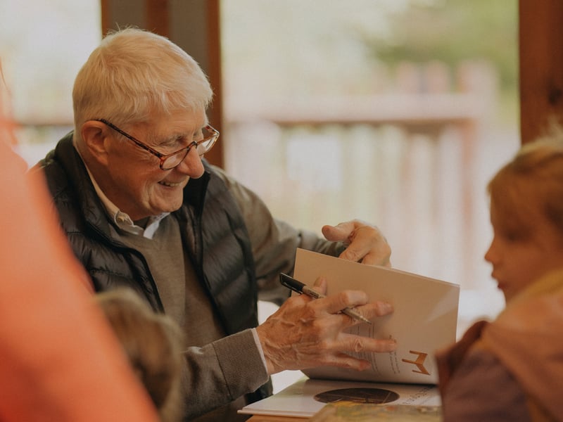Nick Butterworth signing a book at Forest Holidays