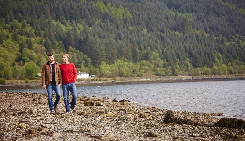 Couple walking beside the loch