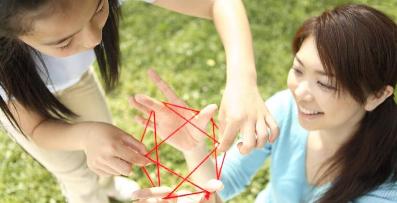 Girls playing Cats Cradle 