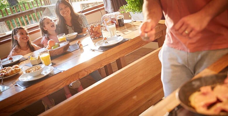 Family having breakfast inside the cabin