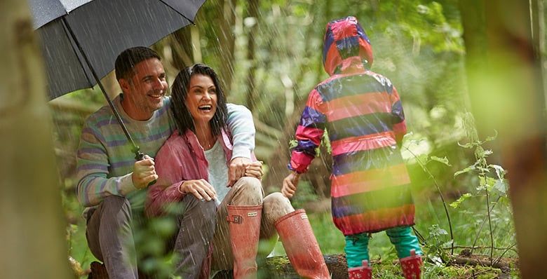 Family in the forest on a rainy day