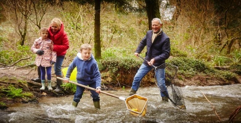 Grandparents and grandkids pond dipping at Deerpark, Cornwall
