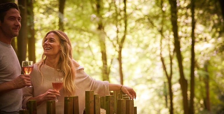 Couple on the outside decking at Forest Holidays