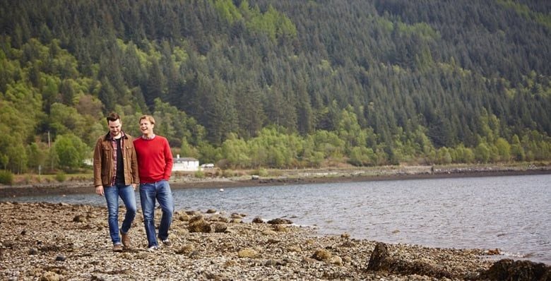Couple walking by the loch in Scotland