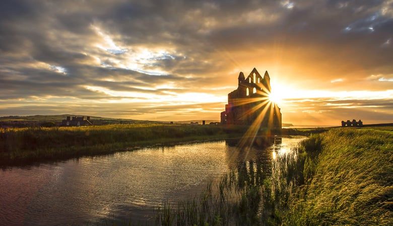 Sunlight glistens on the ruins of Whitby Abbey