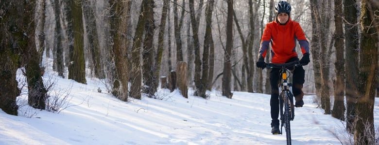 Cyclist in a snowy forest