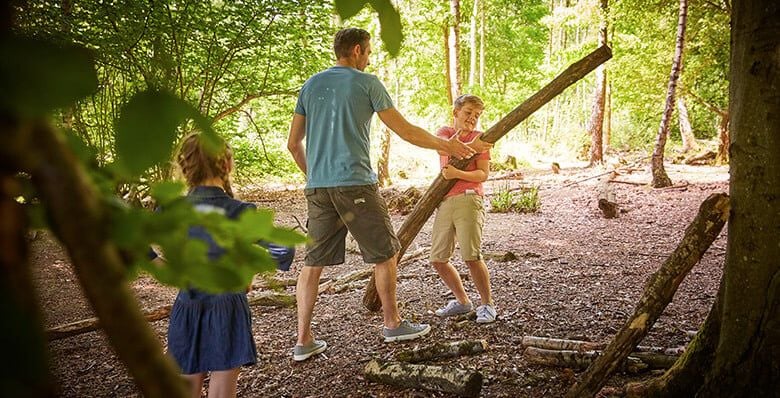 Family playing in the forest
