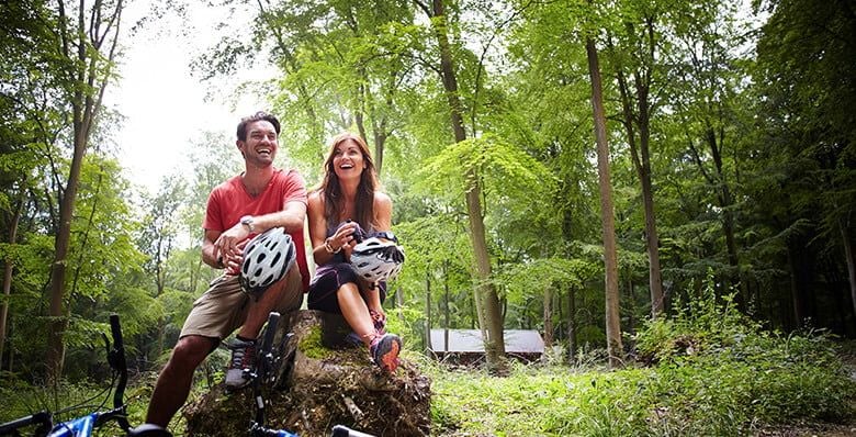 Couple in the forest with cycle hire